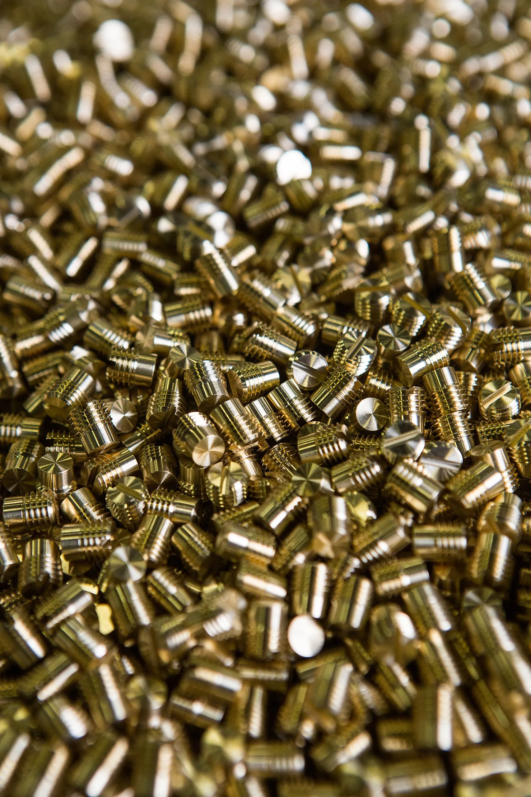 Close view of small brass parts in a pile