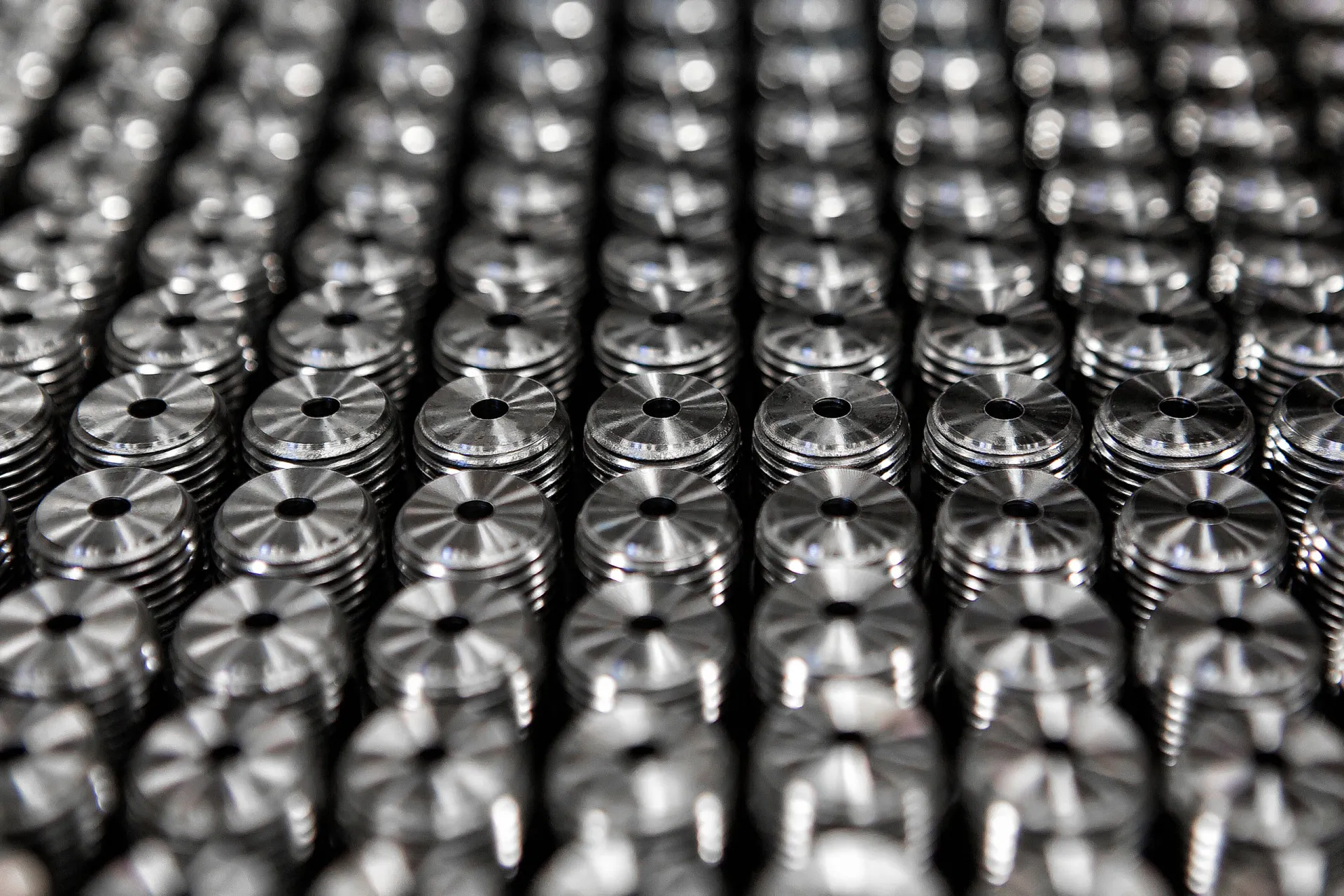 A tray of identical machined parts arranged in tight rows