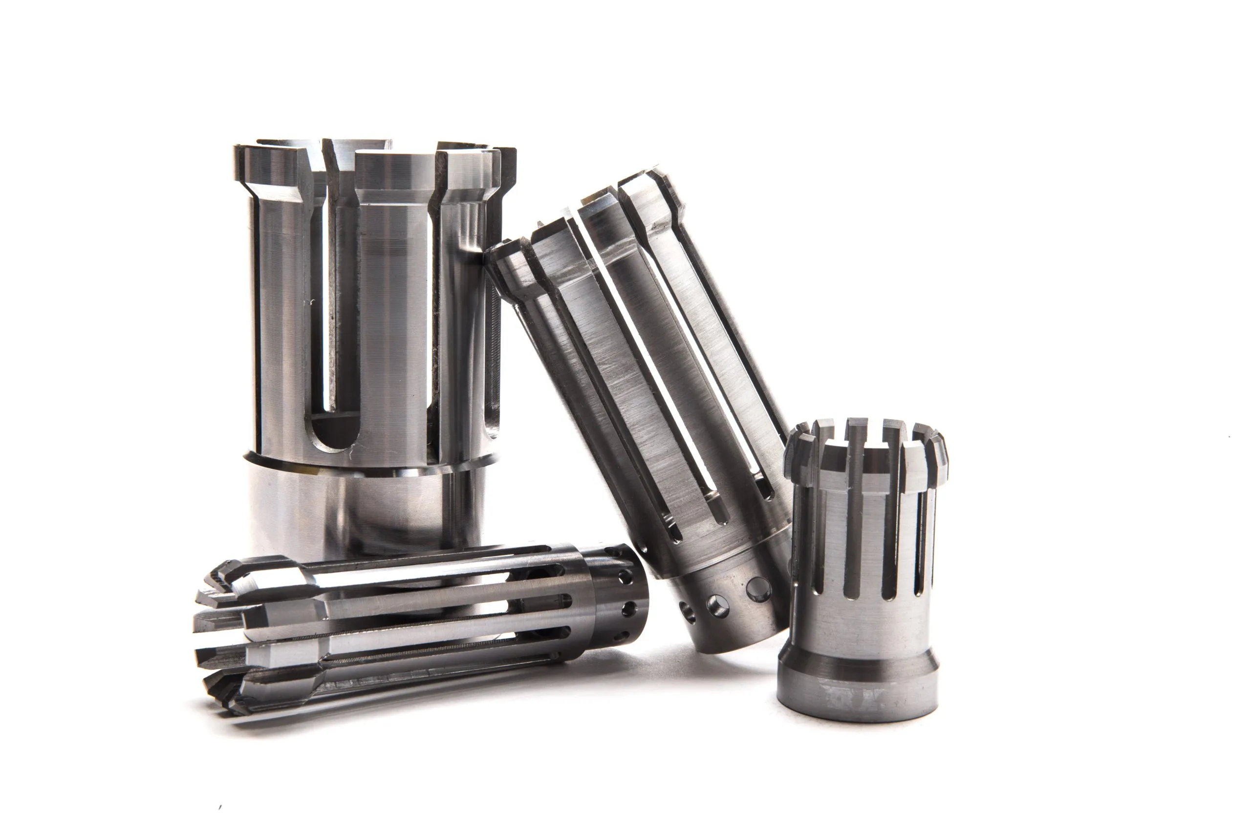 Slotted steel sleeves photographed on white