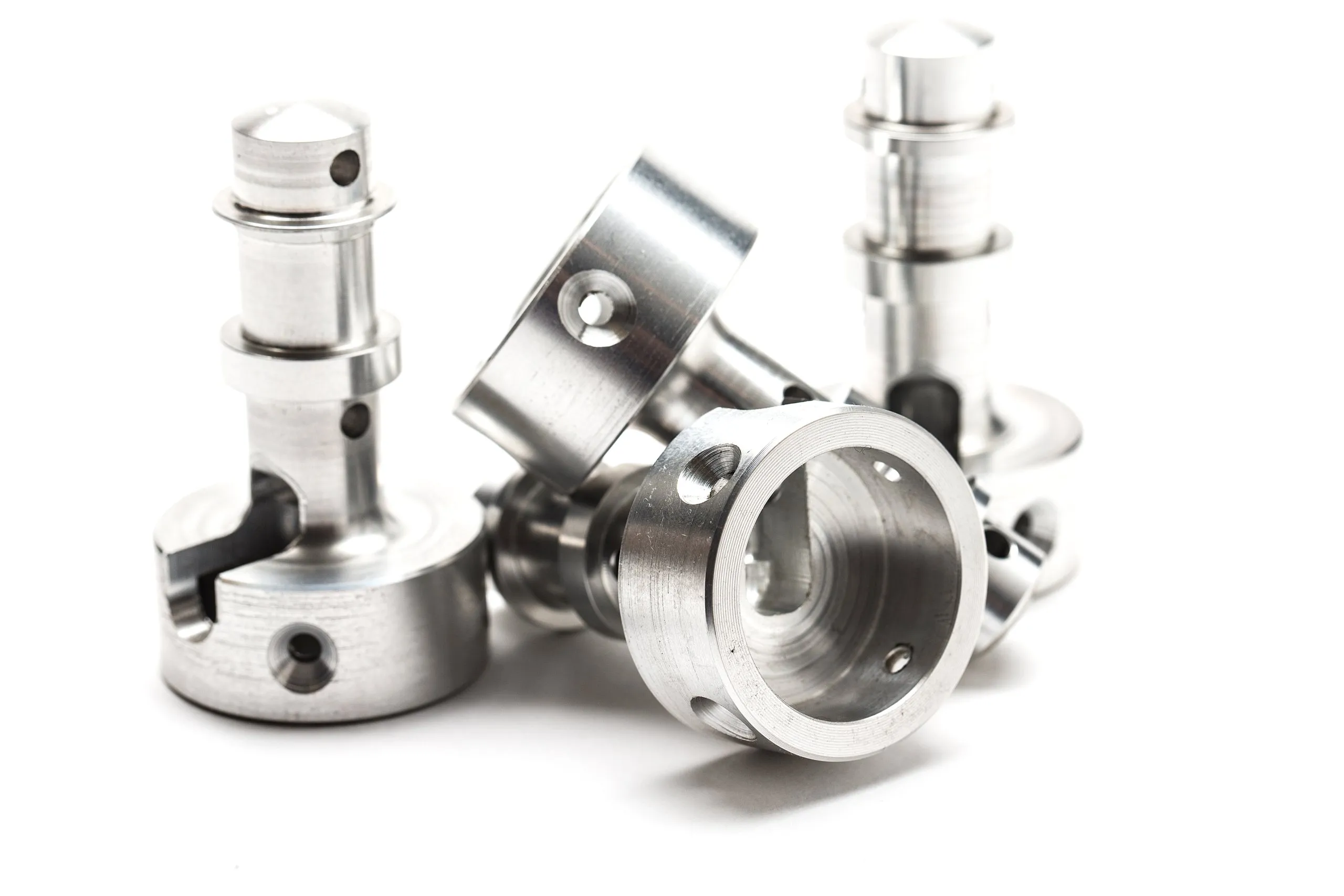 A group of machined steel fittings photographed on white